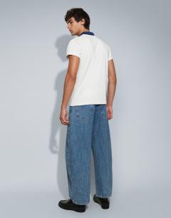 Model wearing Rigid barrel fit jean in mid wash