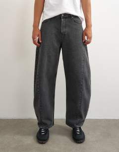 Model wearing Rigid barrel fit jean in washed black