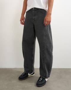 Model wearing Rigid barrel fit jean in washed black