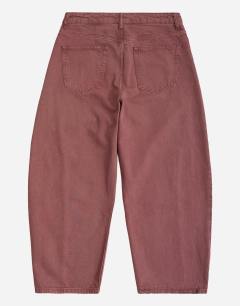 Model wearing Rigid barrel fit jean in washed burgundy