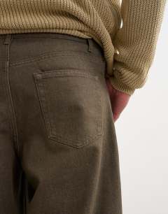 Model wearing Rigid barrel fit jean in washed green