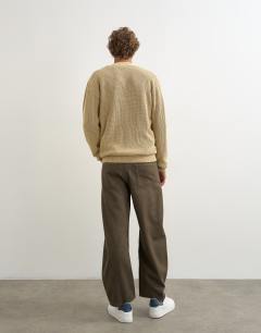 Model wearing Rigid barrel fit jean in washed green