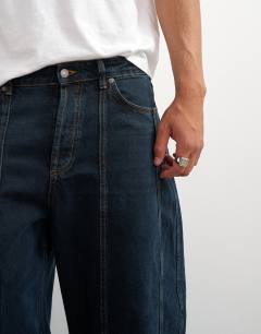 Model wearing Rigid barrel fit panelled jean in clean dark wash