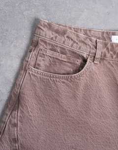 Model wearing Rigid barrel jean in brown