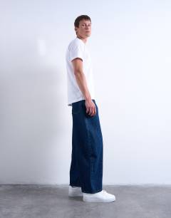 Model wearing Rigid barrel jean in dark wash