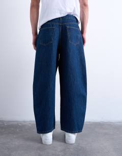 Model wearing Rigid barrel jean in dark wash
