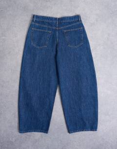 Model wearing Rigid barrel jean in dark wash