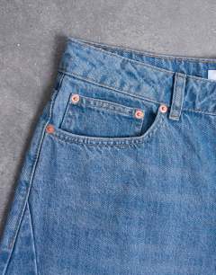 Model wearing Rigid barrel jean in mid wash