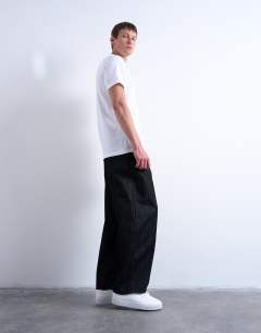 Model wearing Rigid barrel jean in raw black