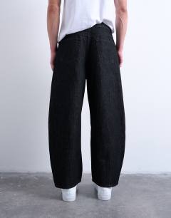 Model wearing Rigid barrel jean in raw black