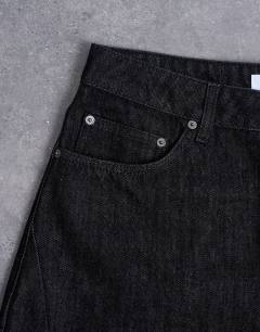 Model wearing Rigid barrel jean in raw black