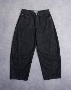 Model wearing Rigid barrel jean in raw black