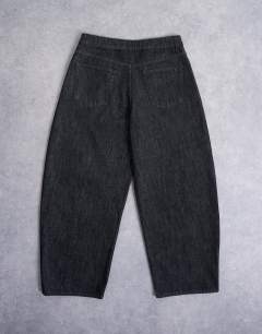 Model wearing Rigid barrel jean in raw black