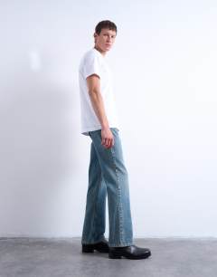 Model wearing Rigid flare jean in mid wash