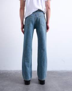 Model wearing Rigid flare jean in mid wash