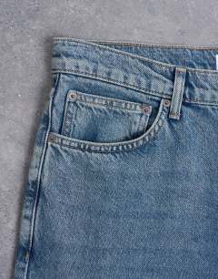 Model wearing Rigid flare jean in mid wash