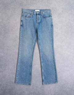 Model wearing Rigid flare jean in mid wash