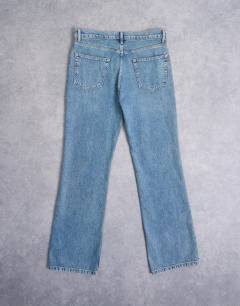 Model wearing Rigid flare jean in mid wash