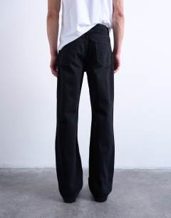 Model wearing Rigid flare jean in washed black