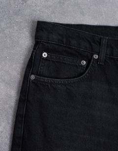 Model wearing Rigid flare jean in washed black