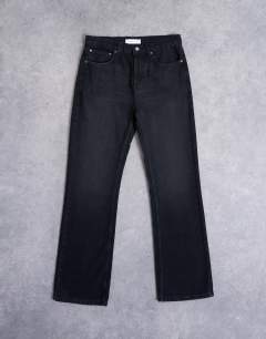 Model wearing Rigid flare jean in washed black