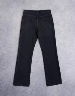 Model wearing Rigid flare jean in washed black