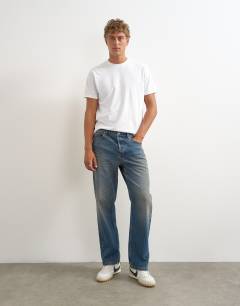 Model wearing Rigid straight fit jean with tint in mid wash