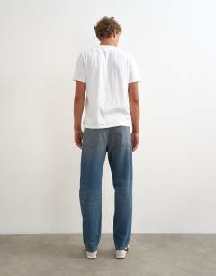 Model wearing Rigid straight fit jean with tint in mid wash