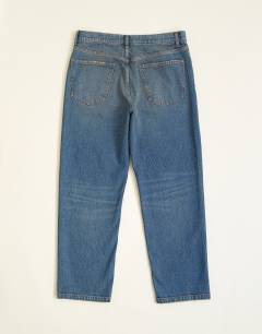 Model wearing Rigid straight fit jean with tint in mid wash