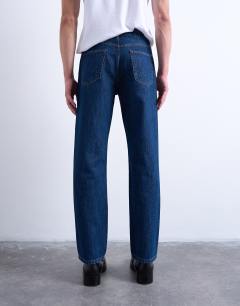 Model wearing Rigid straight jean in dark wash blue