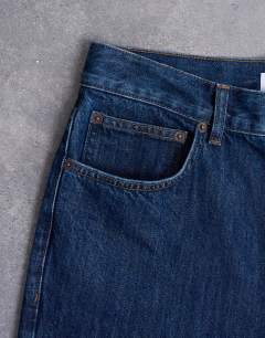Model wearing Rigid straight jean in dark wash blue
