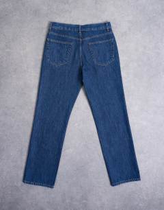 Model wearing Rigid straight jean in dark wash blue