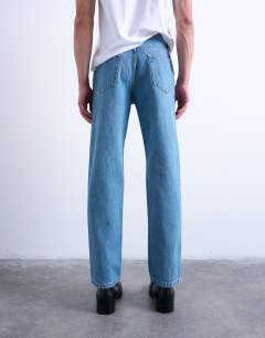 Model wearing Rigid straight jean in mid wash