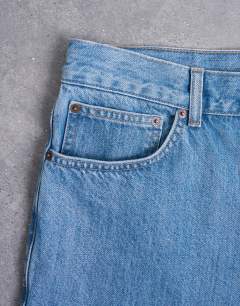 Model wearing Rigid straight jean in mid wash