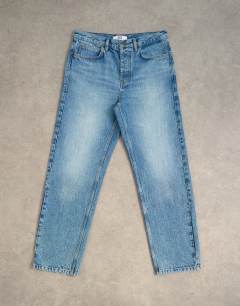 Model wearing Rigid straight jean in mid wash