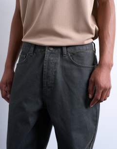 Model wearing Rigid straight leg jean in brown coated