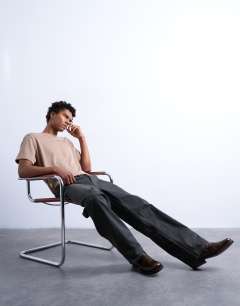 Model wearing Rigid straight leg jean in brown coated