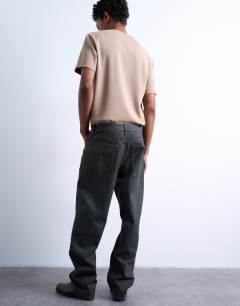 Model wearing Rigid straight leg jean in brown coated