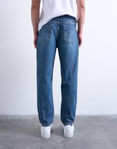 Model wearing Rigid taper jean in mid wash