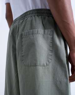 Model wearing Ripstop barrel trousers in khaki