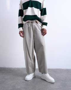 Model wearing Ripstop barrel trousers in stone