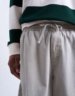 Model wearing Ripstop barrel trousers in stone