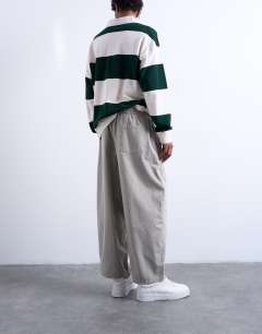 Model wearing Ripstop barrel trousers in stone