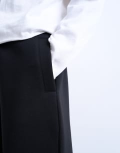 Model wearing Scuba-style fabric jogger in black