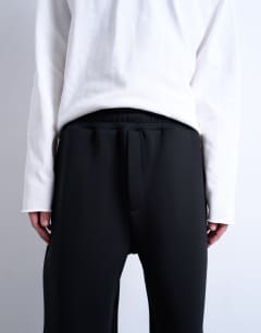 Model wearing Scuba-style fabric jogger in black