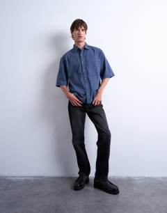 Model wearing Short sleeve boxy textured shirt in mid blue