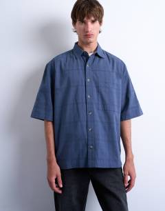 Model wearing Short sleeve boxy textured shirt in mid blue