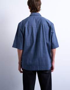 Model wearing Short sleeve boxy textured shirt in mid blue