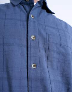 Model wearing Short sleeve boxy textured shirt in mid blue