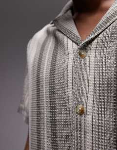 Model wearing Short sleeve revere stripe shirt in green and white